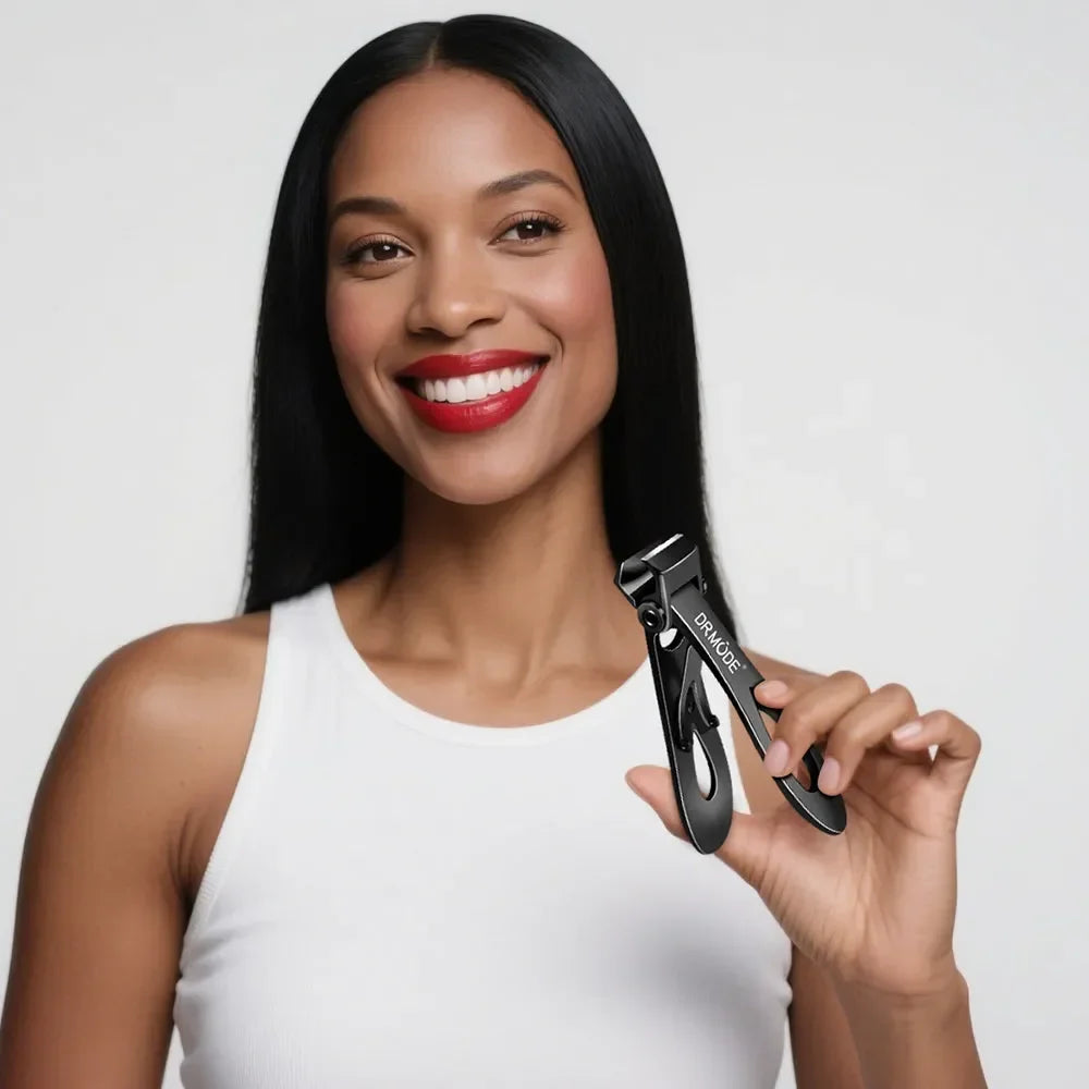 Woman smiling and holding black nail clippers in hand, isolated on white background.