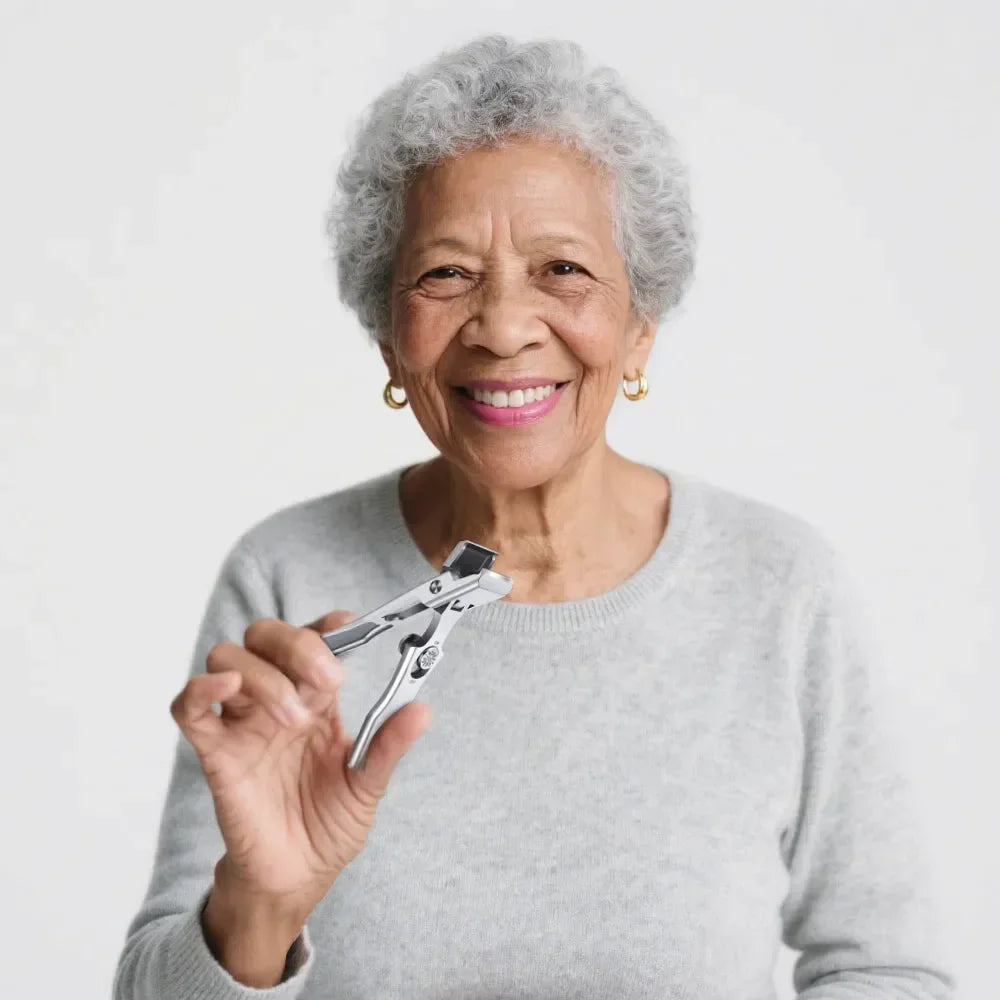 Smiling elderly woman holding precision nail clippers against a plain light background