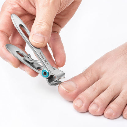 Hand using an open wide-jaw toenail clipper to trim a thick toenail, featuring a clear line of sight design that eliminates guesswork and prevents accidental nicks for stress-free grooming.